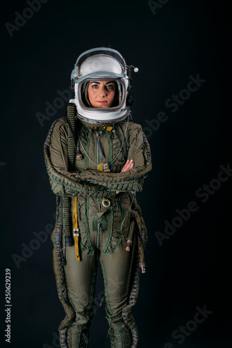 Young astronaut woman with helmet in studio