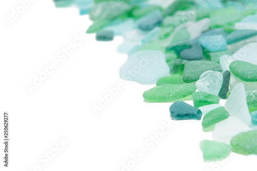 Green glass stones on a white isolated background, copy space, vacation concept photo