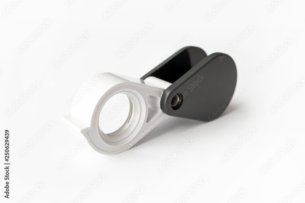 Magnifying glass for diamonds or see the amulet Isolated on a White Background. Magnifying glass for diamonds or see the amulet Isolated on a White Background.