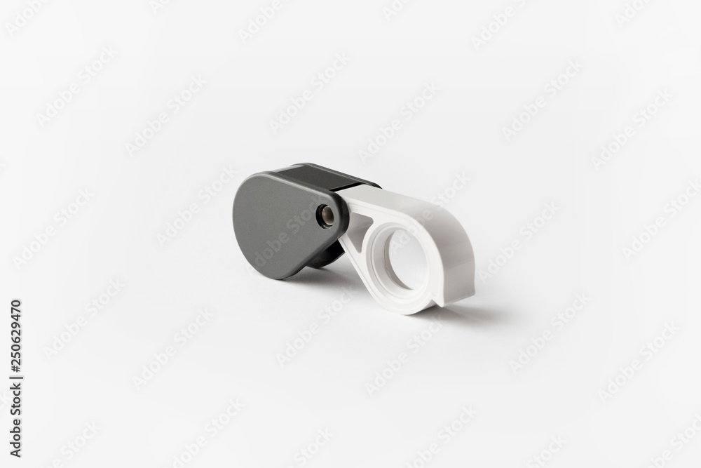 Magnifying glass for diamonds or see the amulet Isolated on a White Background. Magnifying glass for diamonds or see the amulet Isolated on a White Background.