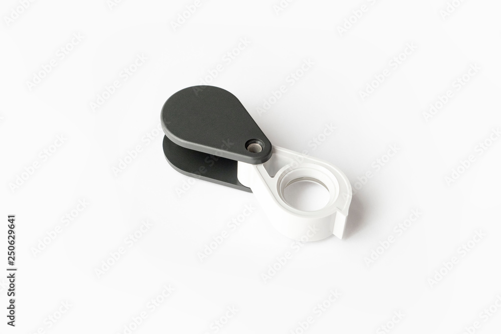 Magnifying glass for diamonds or see the amulet Isolated on a White Background. Magnifying glass for diamonds or see the amulet Isolated on a White Background.