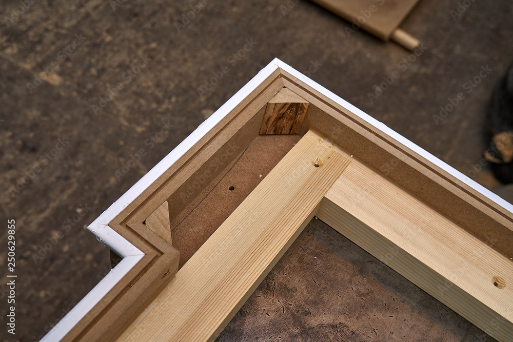 Crown molding. Home library with classic design. Wooden furniture manufacturing process Crown molding. Home library with classic design. Wooden furniture manufacturing process