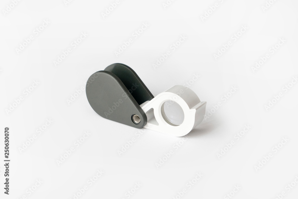 Magnifying glass for diamonds or see the amulet Isolated on a White Background. Magnifying glass for diamonds or see the amulet Isolated on a White Background.