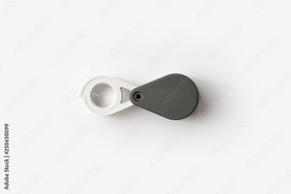 Magnifying glass for diamonds or see the amulet Isolated on a White Background. Magnifying glass for diamonds or see the amulet Isolated on a White Background.