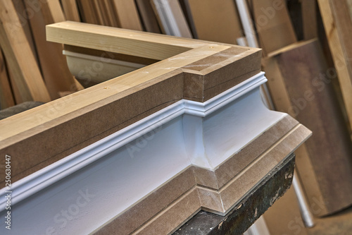 Crown molding. Home library with classic design. Wooden furniture manufacturing process