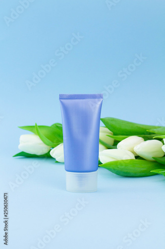 Wallpaper Mural Vertical blank packaging cosmetic plastic bottle with fresh flowers on pastel blue background, close up mockup face cream Torontodigital.ca
