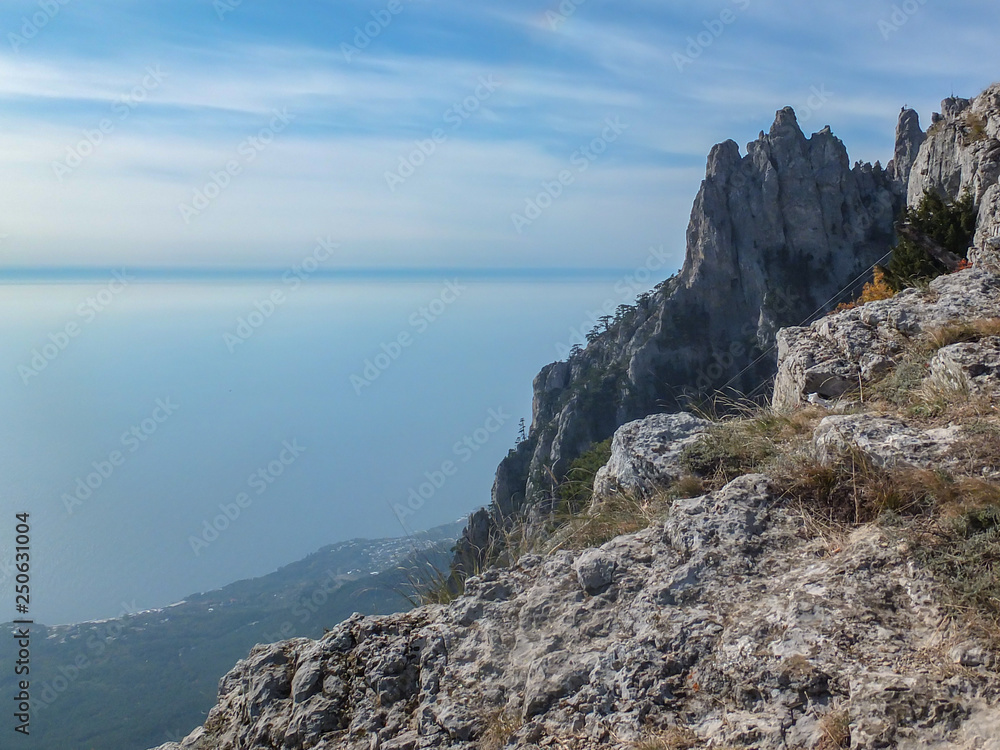 Magnificent view of highest mountain of Crimea Ai-Petri and blue water of Black Sea. Autumn landscape favorite tourist routes. Place for your text.