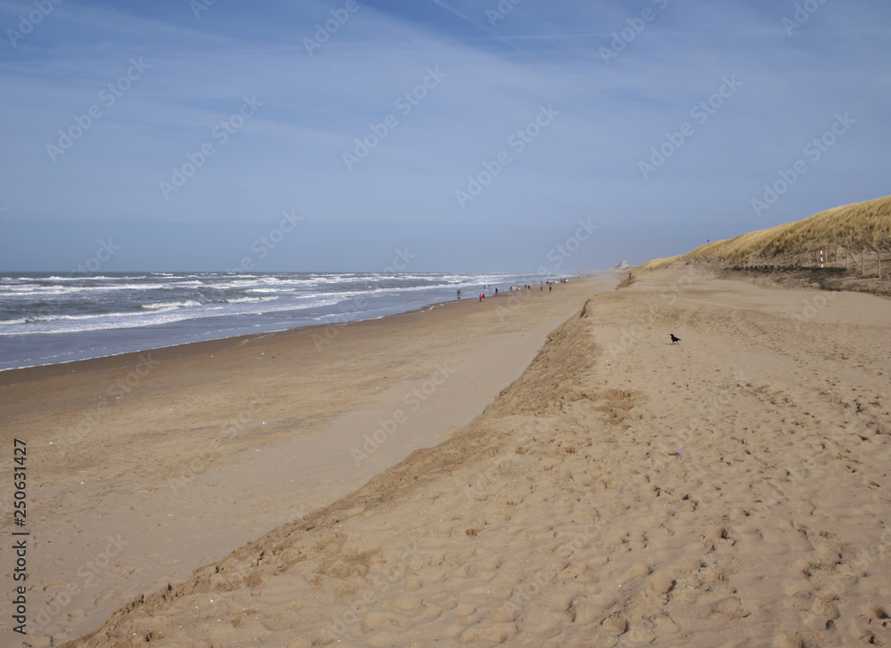 view down the beach of Katwijk with distant people