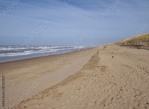 view down the beach of Katwijk with distant people