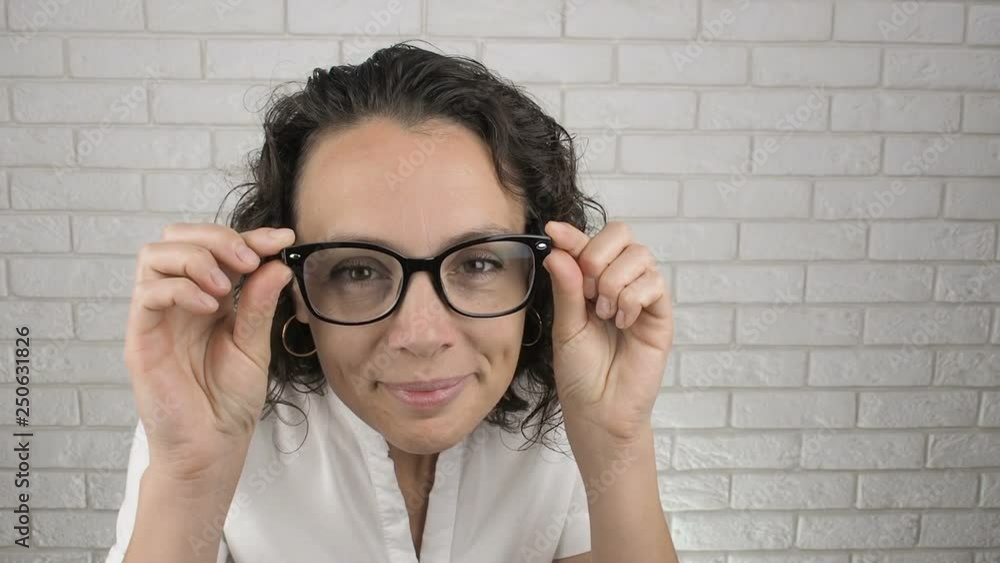 A woman with glasses eyeing. Cute woman with glasses looks at the camera. A woman with glasses eyeing. Cute woman with glasses looks at the camera.