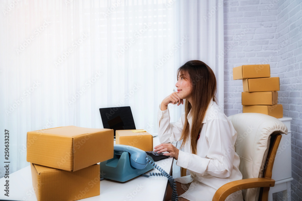 Women small business owner working at home with packing box on workplace. online shopping SME entrepreneur or freelance working concept. Women small business owner working at home with packing box on workplace. online shopping SME entrepreneur or freelance working concept.
