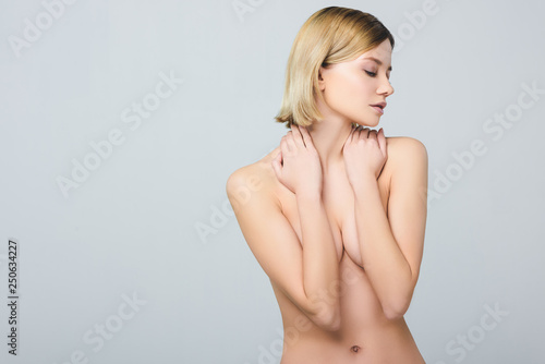 фотографія beautiful naked tender girl covering breast, isolated on grey