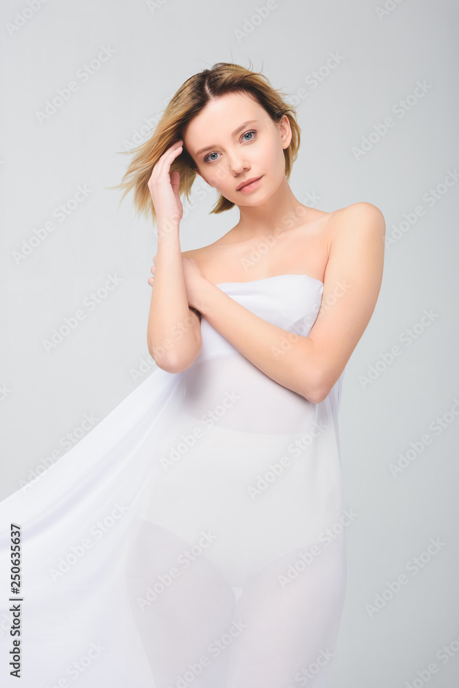elegant attractive girl posing in white cloth, isolated on grey elegant attractive girl posing in white cloth, isolated on grey