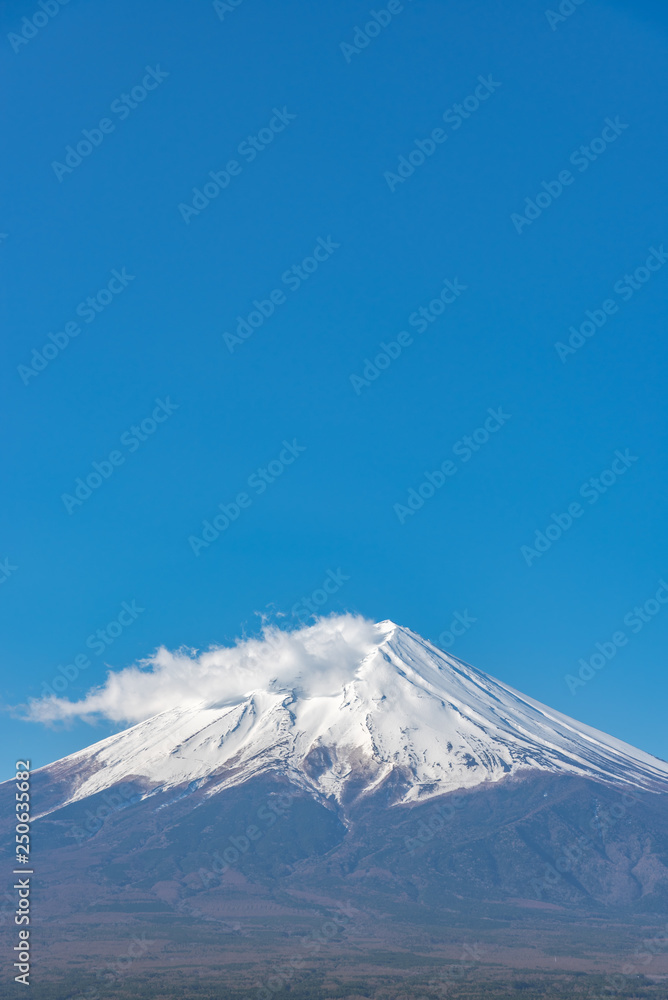 Close-up snow covered Mount Fuji ( Mt. Fuji ) in clear blue sky background on winter season. Fujiyoshida City, Yamanashi Prefecture, Japan Close-up snow covered Mount Fuji ( Mt. Fuji ) in clear blue sky background on winter season. Fujiyoshida City, Yamanashi Prefecture, Japan