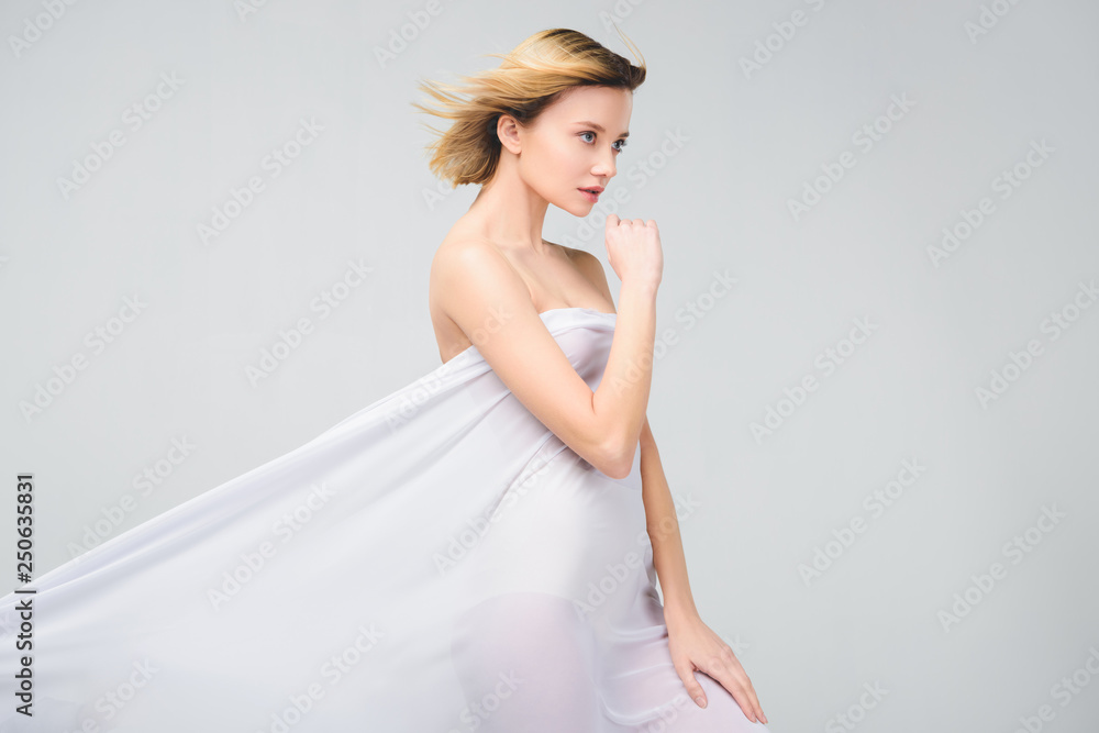 elegant naked girl posing in white cloth, isolated on grey elegant naked girl posing in white cloth, isolated on grey
