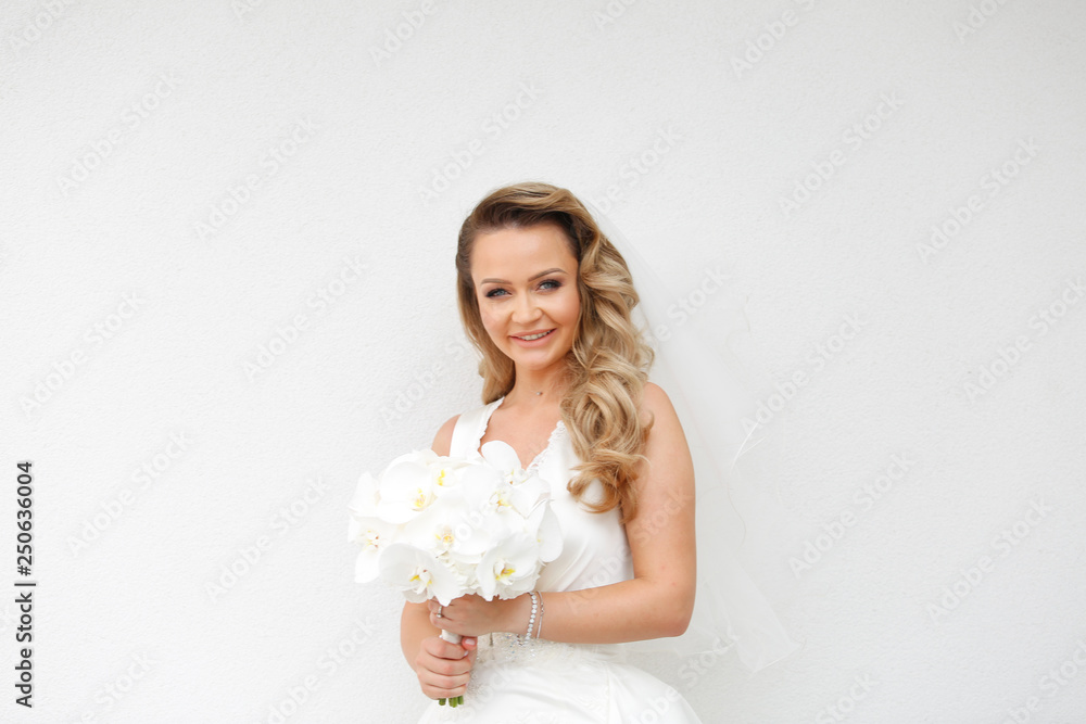 Blonde bride posing with bouquet of flowers Blonde bride posing with bouquet of flowers