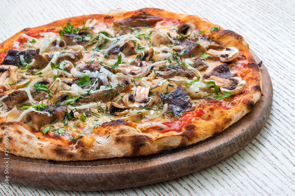 Pizza with mushrooms on a wooden board. On white background.