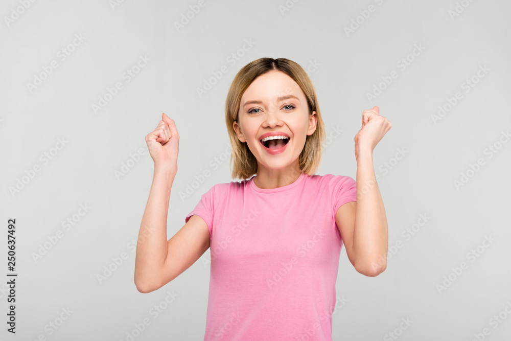 excited attractive blonde woman isolated on grey excited attractive blonde woman isolated on grey