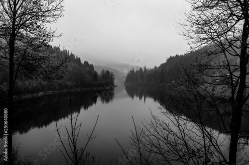 View of Elbe river and surrounding mountains - Giant Mountains (Krkonose). Small town of Spindleruv Mlyn and Labska village. Czech Republic. Black and white.