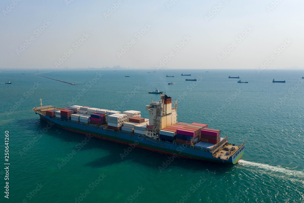 Aerial view. Container ship in pier with crane bridge carries out export and import business in the open sea. Logistics and transportation