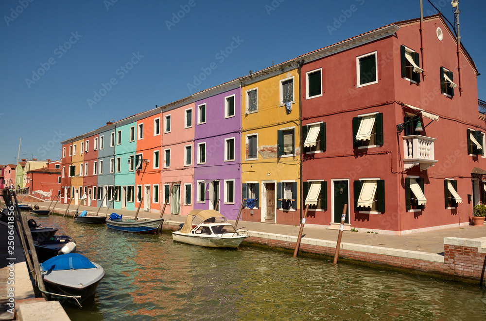 Scenic canal with colorful buildings in Burano island, Venice, Italy