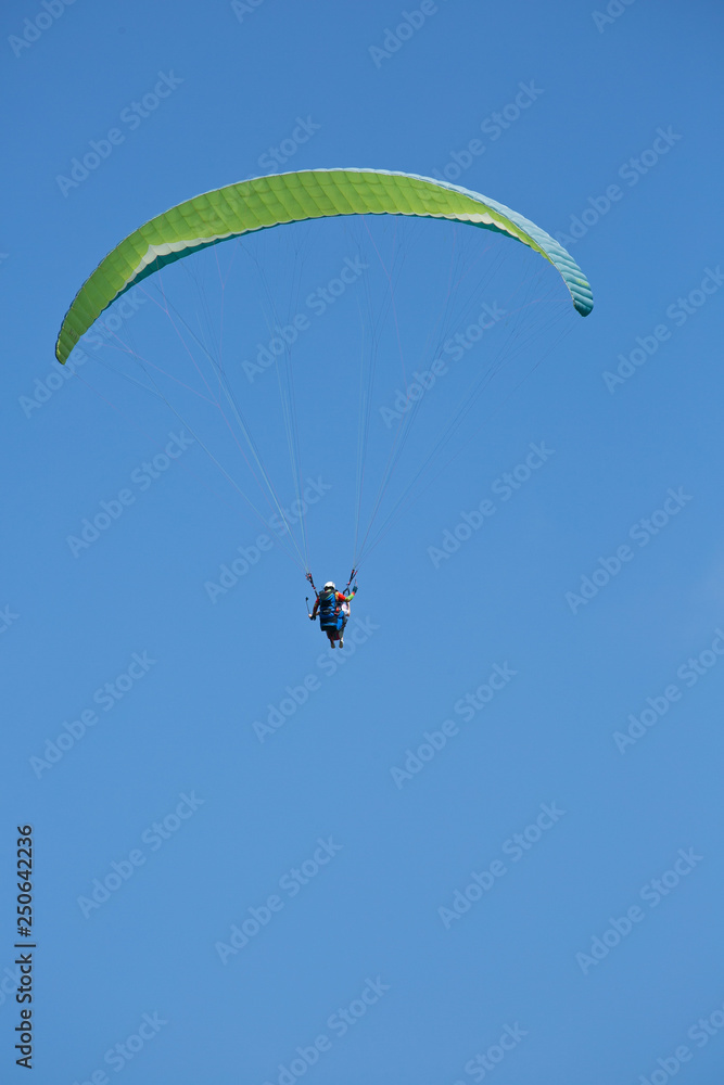 Lone Paraglider seen over the skies of Bali Indonesia Lone Paraglider seen over the skies of Bali Indonesia