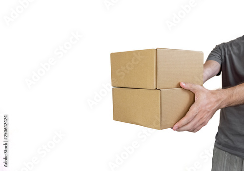 Caucasian man with gray tshirt carrying two parcel boxes on white background