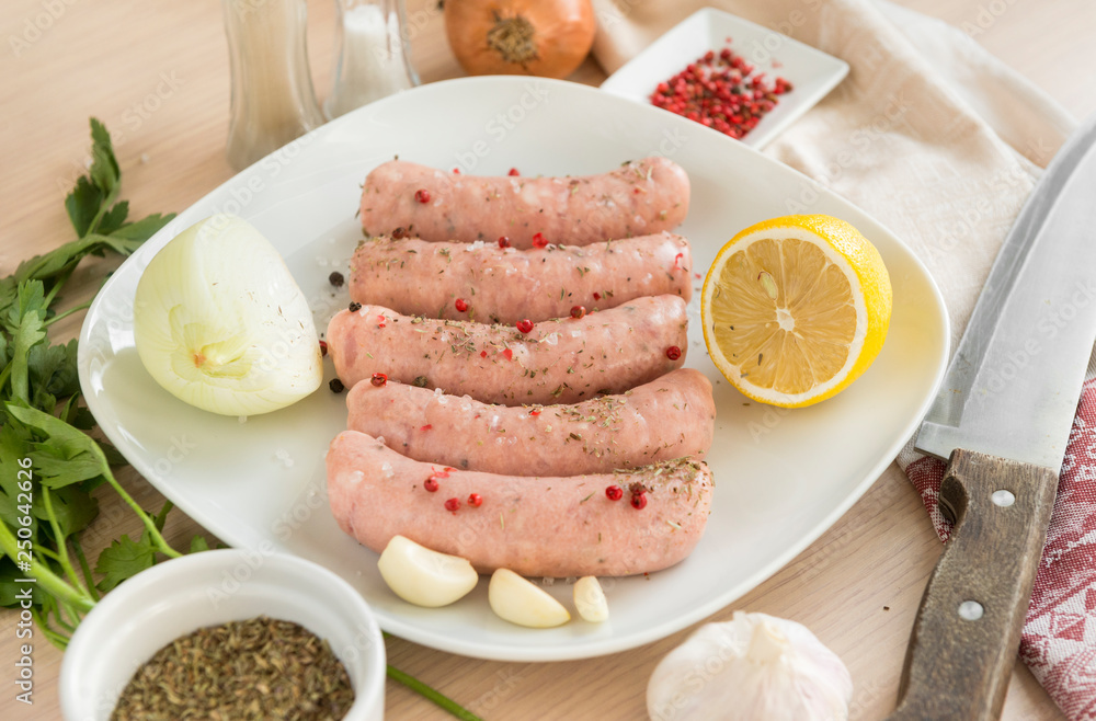 raw sausages, pork sausages on a plate, spices, raw sausages, pork sausages on a plate, spices,