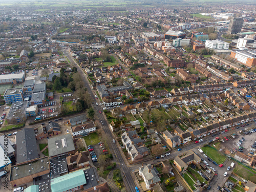 Aerial photo of the town of Aylesbury in the UK showing roads, residential properties, rows of houses and businesses.