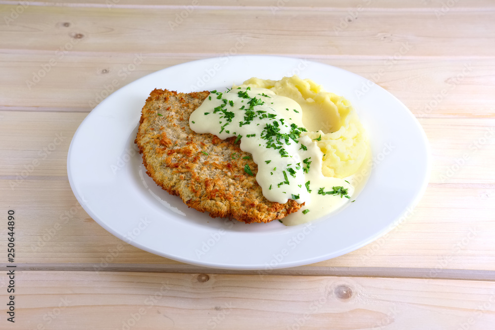 Chopped cutlet in breading with mashed potato and cream sauce Chopped cutlet in breading with mashed potato and cream sauce