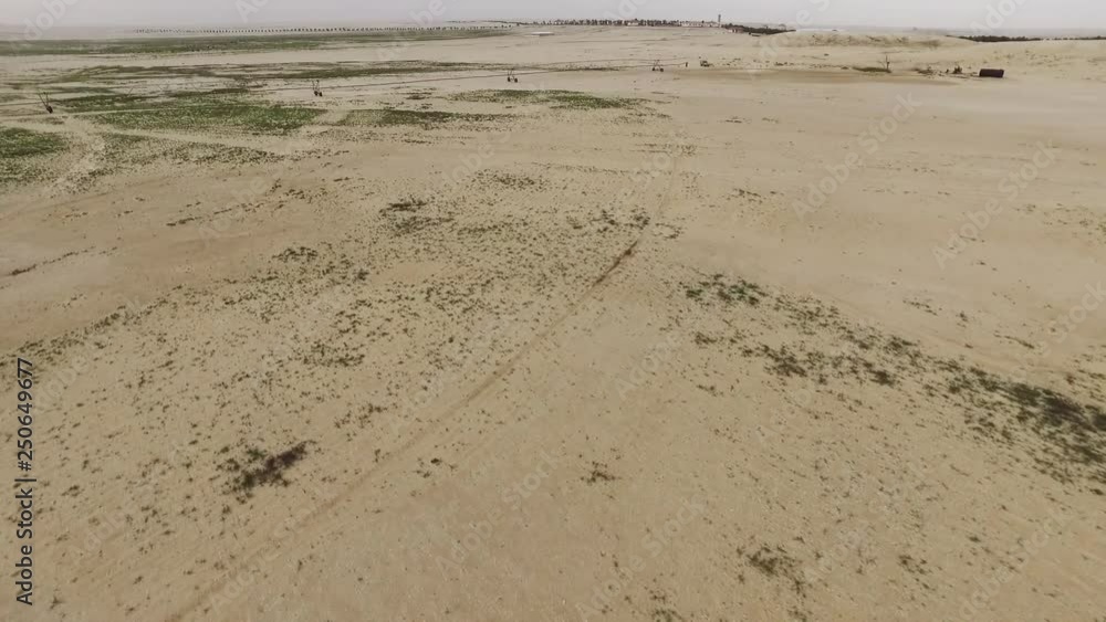 Flying over Dunes over farming in the Desert and showing Irrigation System for farming inside Desert Flying over Dunes over farming in the Desert and showing Irrigation System for farming inside Desert