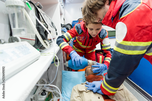 Paramedics in latex gloves doing cardiopulmonary resuscitation photo