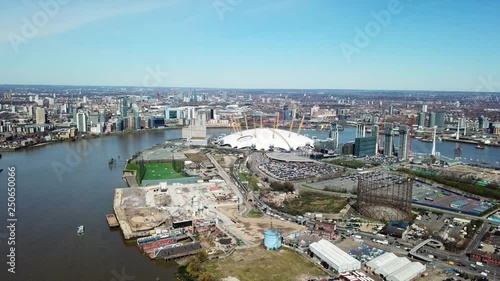 Aerial drone bird's eye view video cruising in river Thames near iconic concert Hall of O2 Arena, London, United Kingdom photo