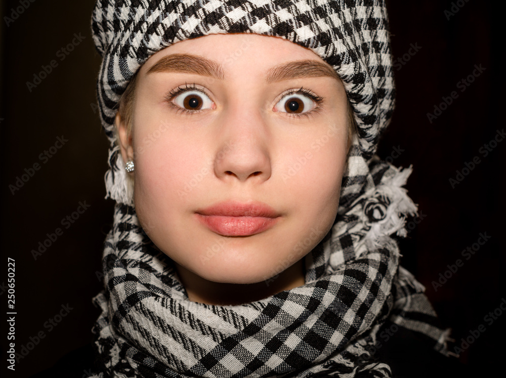 portrait of a young girl with big surprised eyes in arabic clothes closeup portrait of a young girl with big surprised eyes in arabic clothes closeup