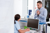 Worried patient looking at nurse in clinic