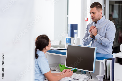 Worried patient looking at nurse in clinic