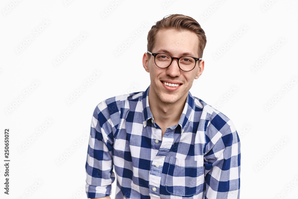 Smiling guy in glasses looking at camera