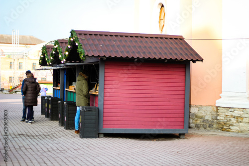 A boutique that sells street food to Kamyanets Podolsk. Street coffee and food. Cocoa, hot dogs. The guy buys food for himself. City center. Day off. photo