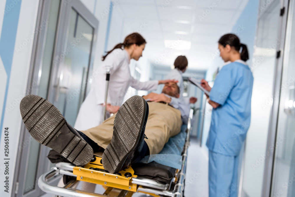 Doctors and nurse transporting patient on gurney Doctors and nurse transporting patient on gurney