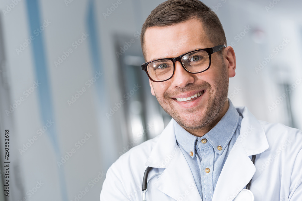 Smiling doctor in glasses looking at camera Smiling doctor in glasses looking at camera