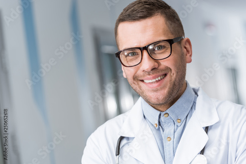 Smiling doctor in glasses looking at camera