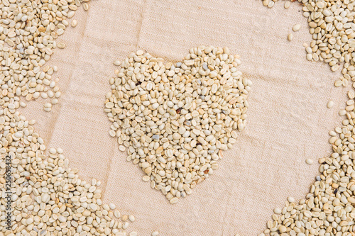 The heart form coffee beans under sun to dry background of coffee bean
