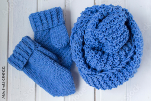 Knitted blue scarf and mittens. Woolen clothes