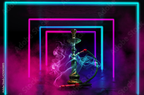 Hookah with smoke on the background of a concrete pavement with multi-colored laser beams, neon light, smoke