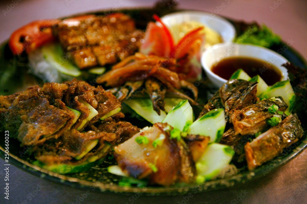 Fish platter on a plate with vegetables in a Chinese restaurant, Guangzhou.