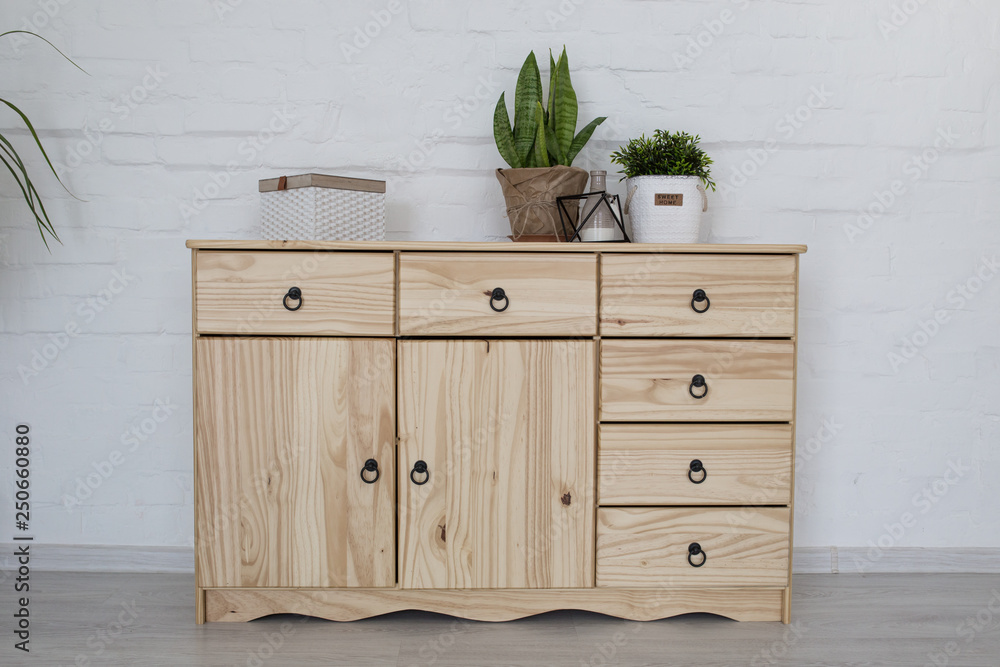 Interior living room with a wooden chest on a white brick wall Interior living room with a wooden chest on a white brick wall
