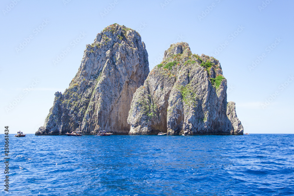 Faraglioni rocks, Capri island, Italy. Mediterranean Sea summer coastal landscape. 