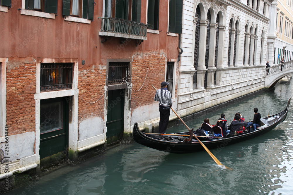 Chinese Tourism sailing travel by Gondola at Grand Canal Venice surrounding by historical attractive building, Venice, Italy, Commercial advertisement for day trip boat in Europe