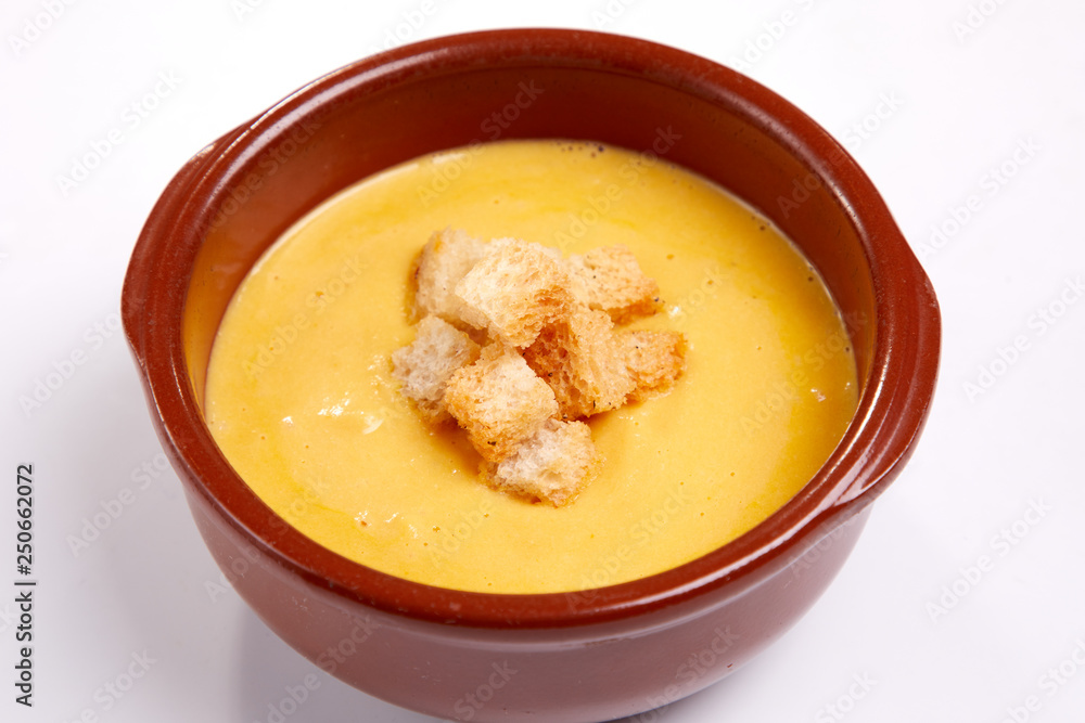 pumpkin cream soup with croutons on the white background pumpkin cream soup with croutons on the white background
