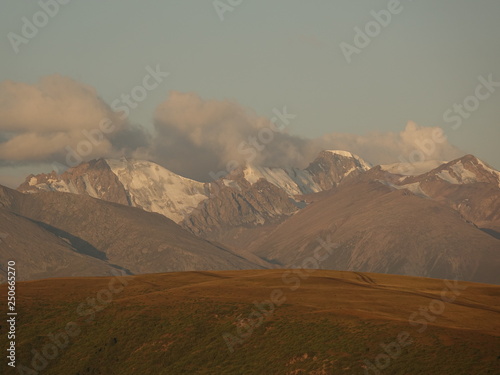 Dawn. Horses on Assy plateau 2665 m. Glaciers and the road in Trans-Ili Alatau. photo